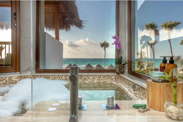 Bathtub with windows looking out to the ocean