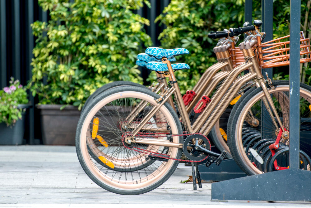 Bikes lined up and locked to a bike rack