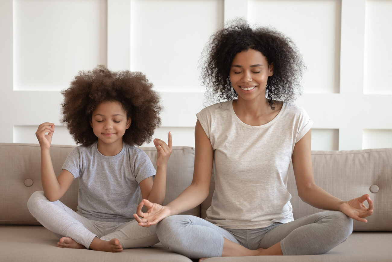 Mother and daughter meditating