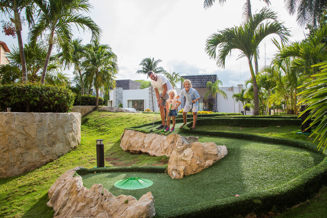 Family playing mini golf