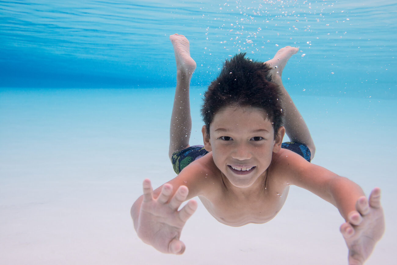 Child underwater posing