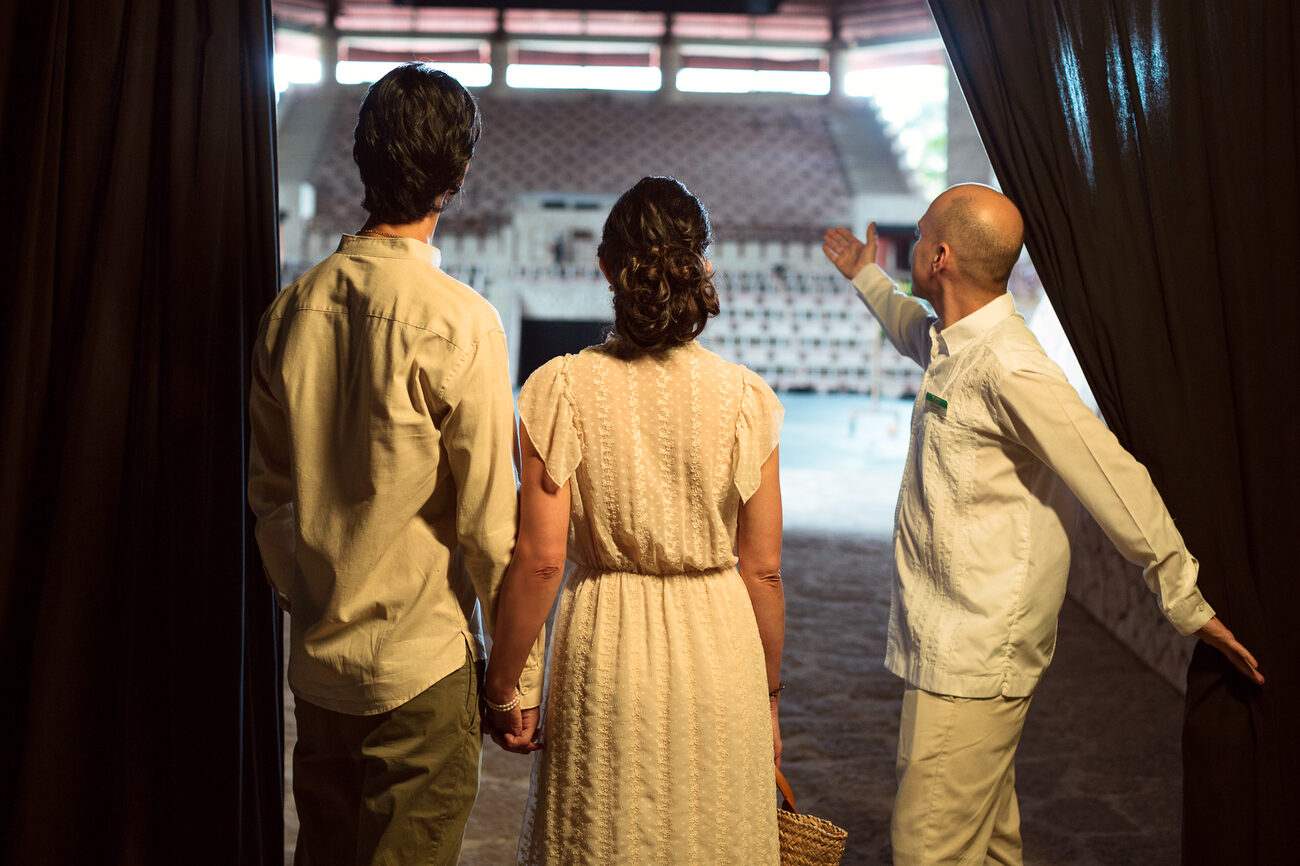 Man giving a tour to a couple holding hands