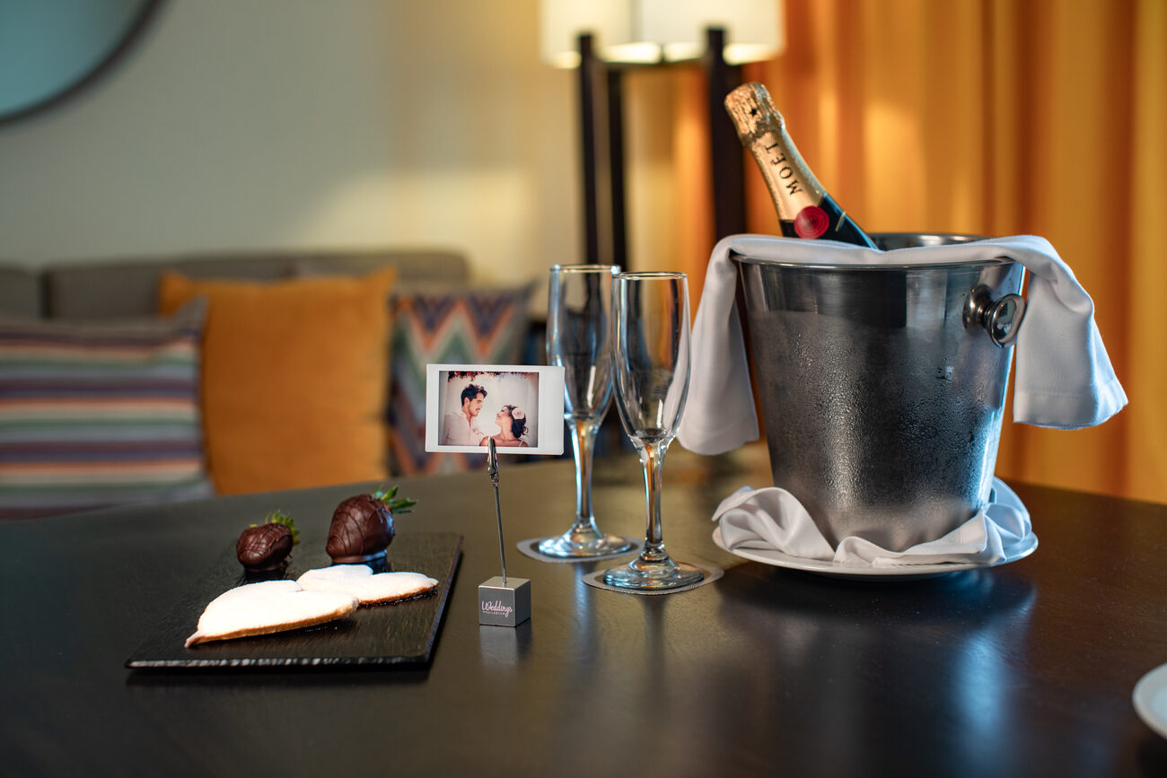 Champagne on ice and glasses with personalized photo and chocolate covered strawberries