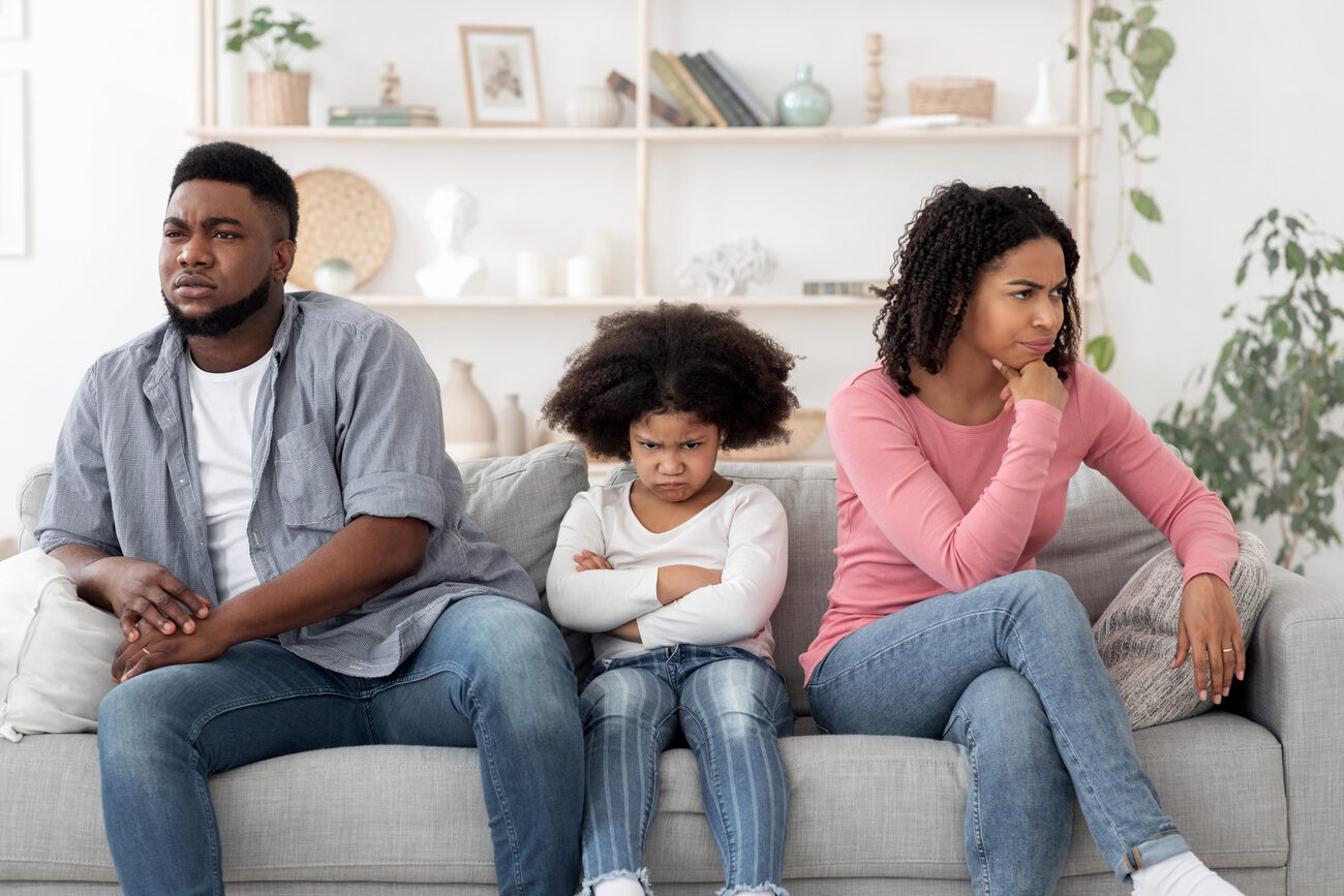 Family sitting together with mad looks on their faces