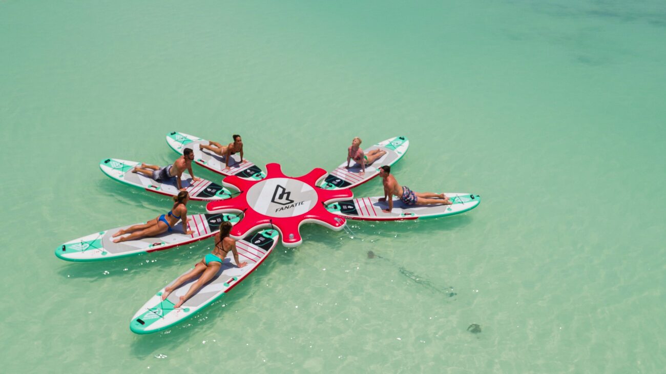 Group doing yoga on paddelboards in the water