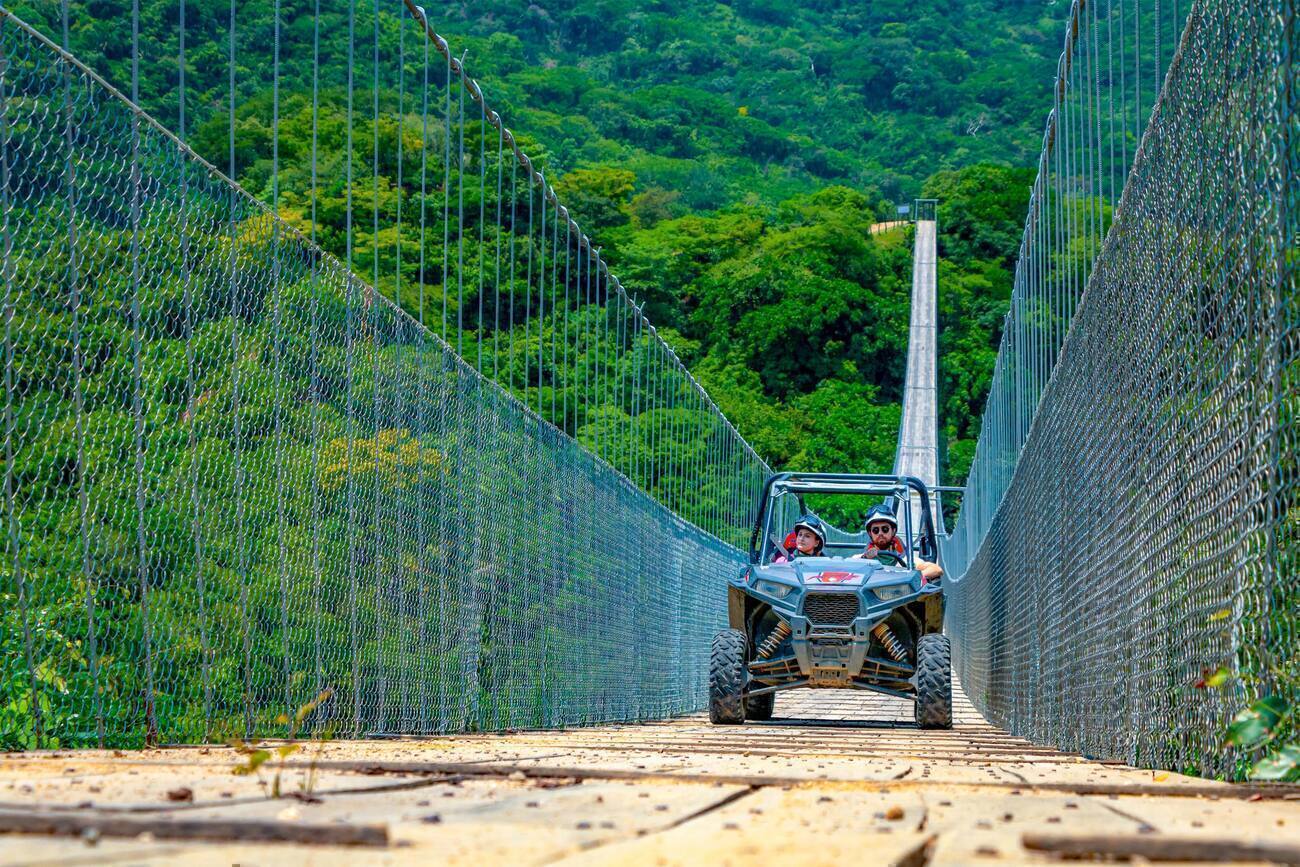 People driving ATV's across a bridge