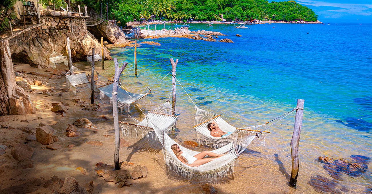 People laying in hammocks on Las Caletas Beach